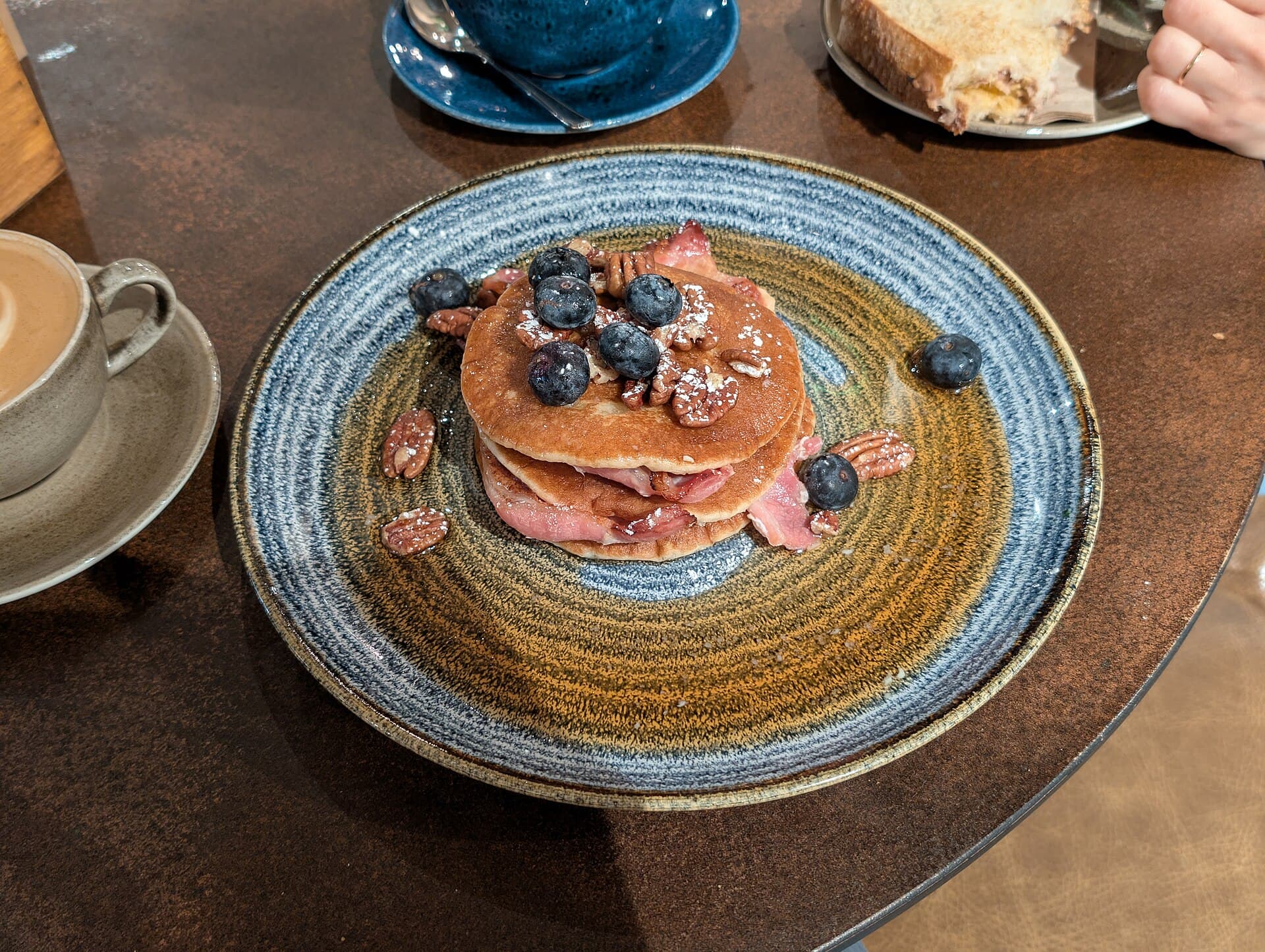 Stack of pancakes with maple syrup and bacon for breakfast recipes