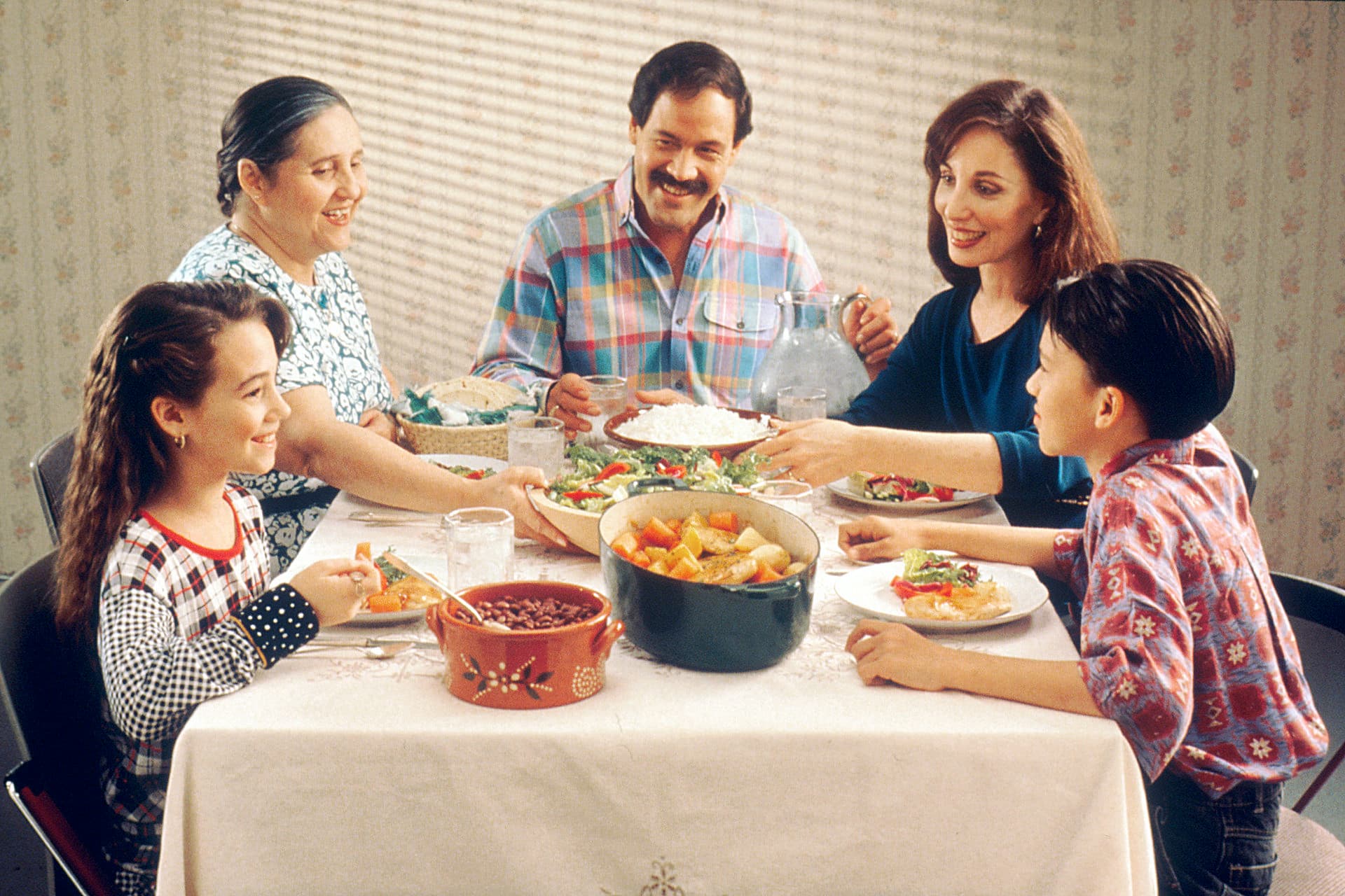 Family sharing a meal around a table for Ouma's Recipes