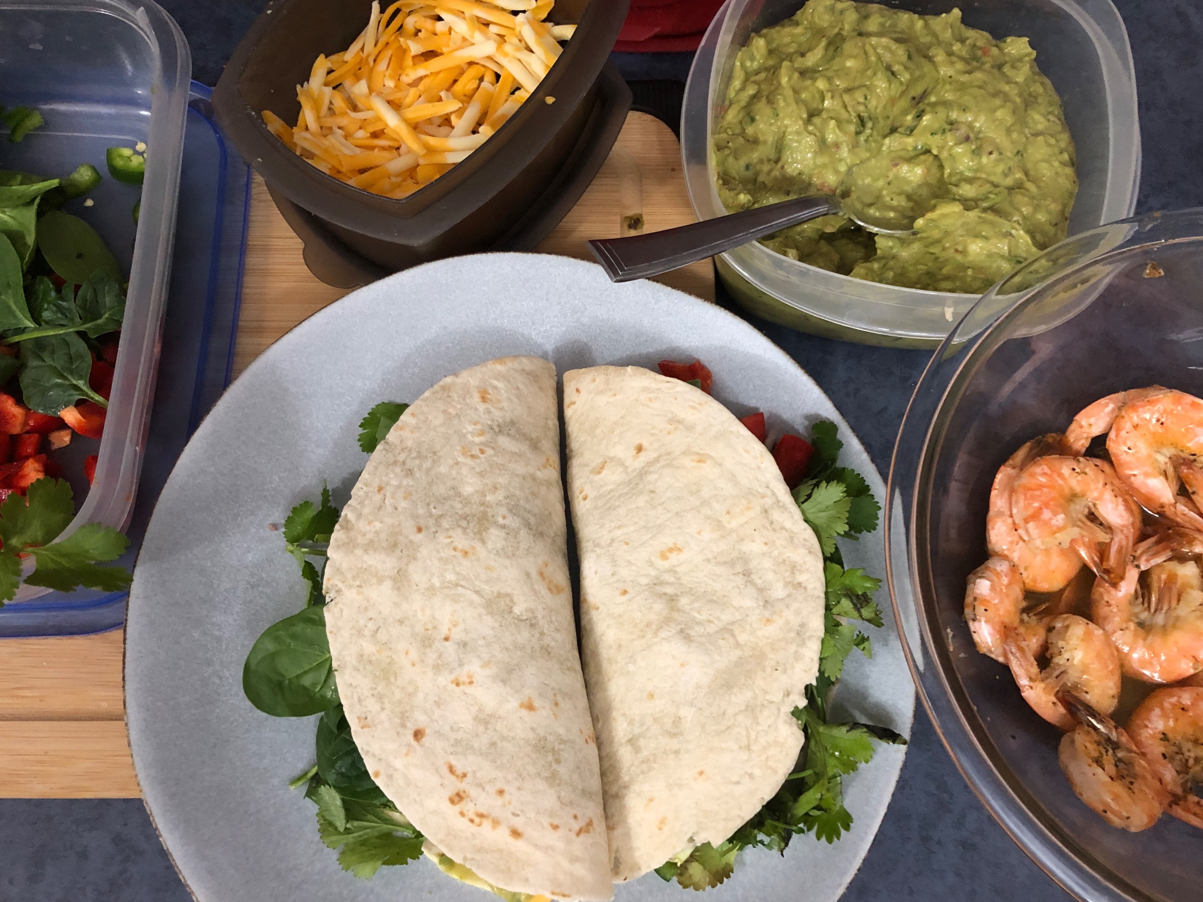 Shrimp tacos with toppings on a plate