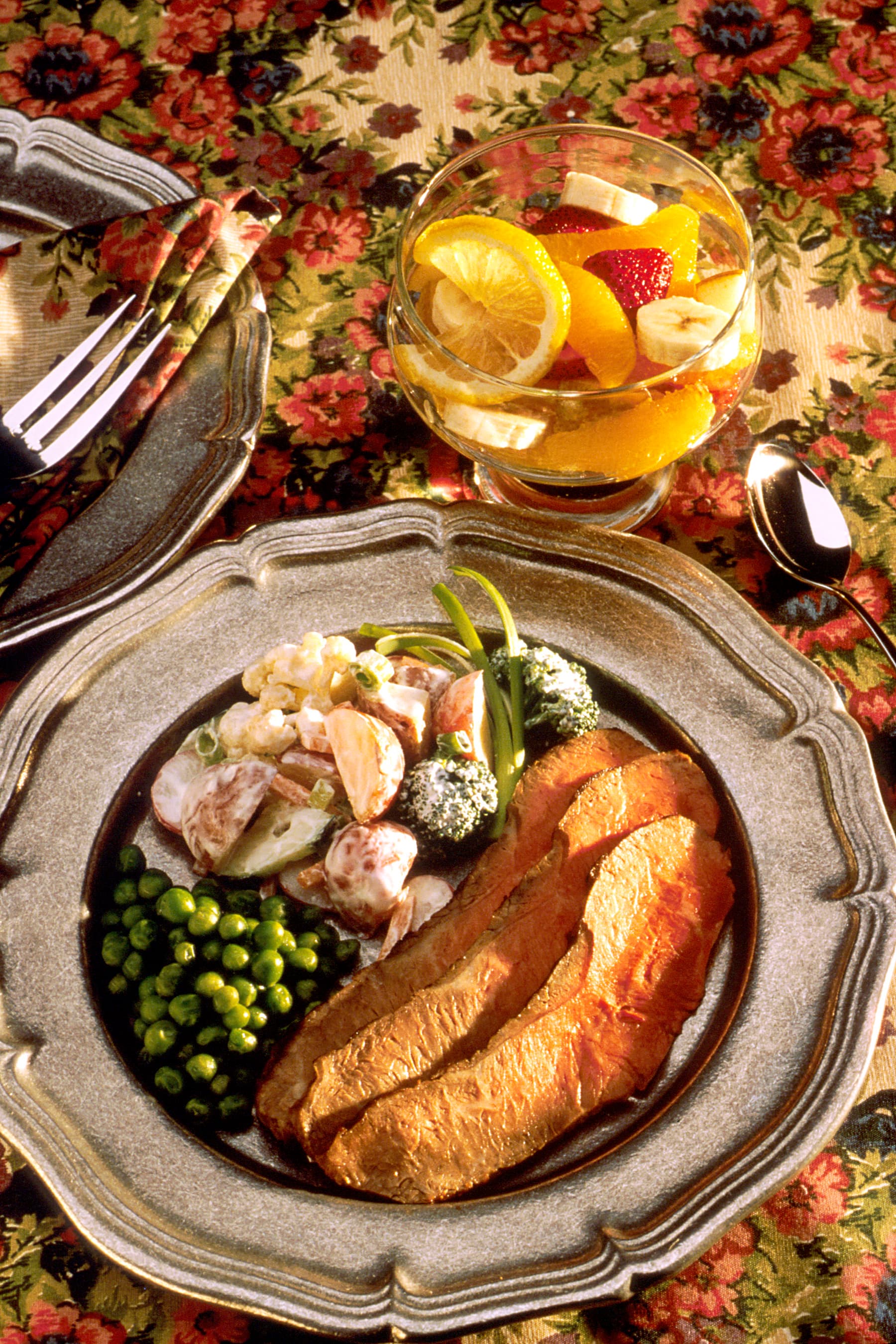 Sliced marinated beef steak served with potato vegetable salad